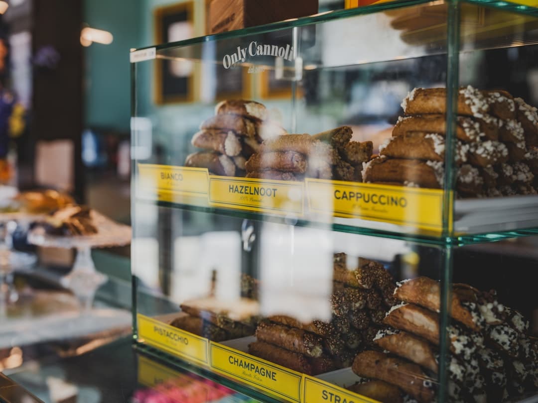 Witryna cukiernicza z różnymi rodzajami sycylijskich cannoli.