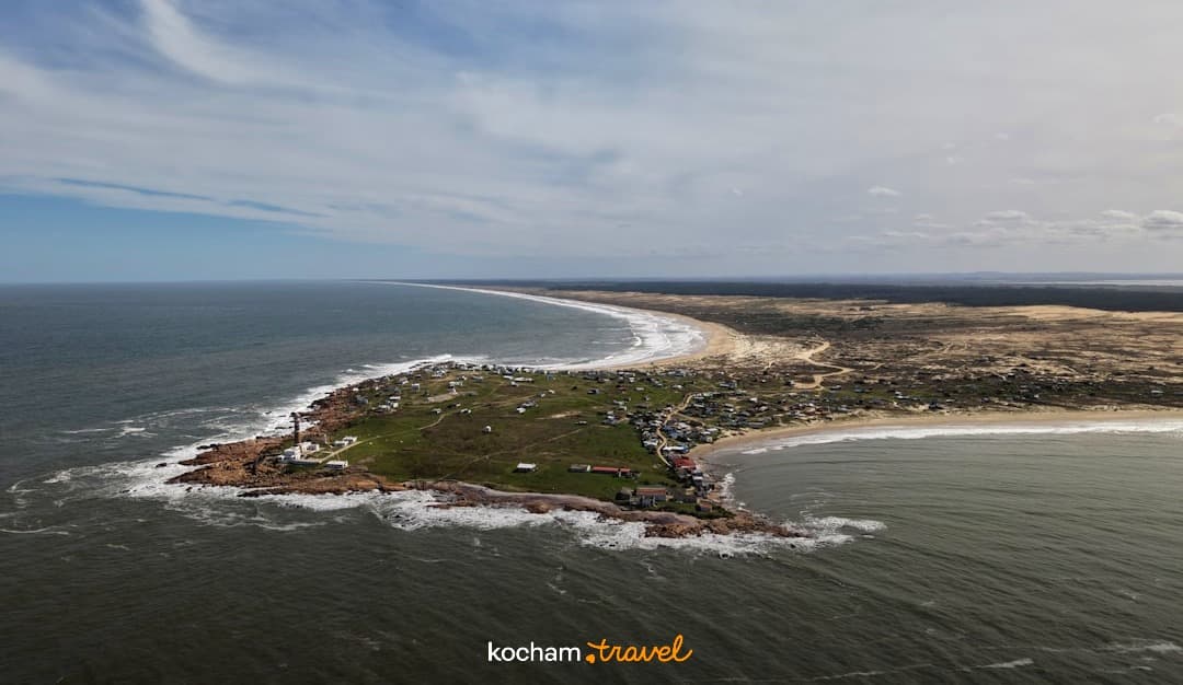 Widok z lotu ptaka: miasto nadmorskie, latarnia morska, plaże, ocean.
