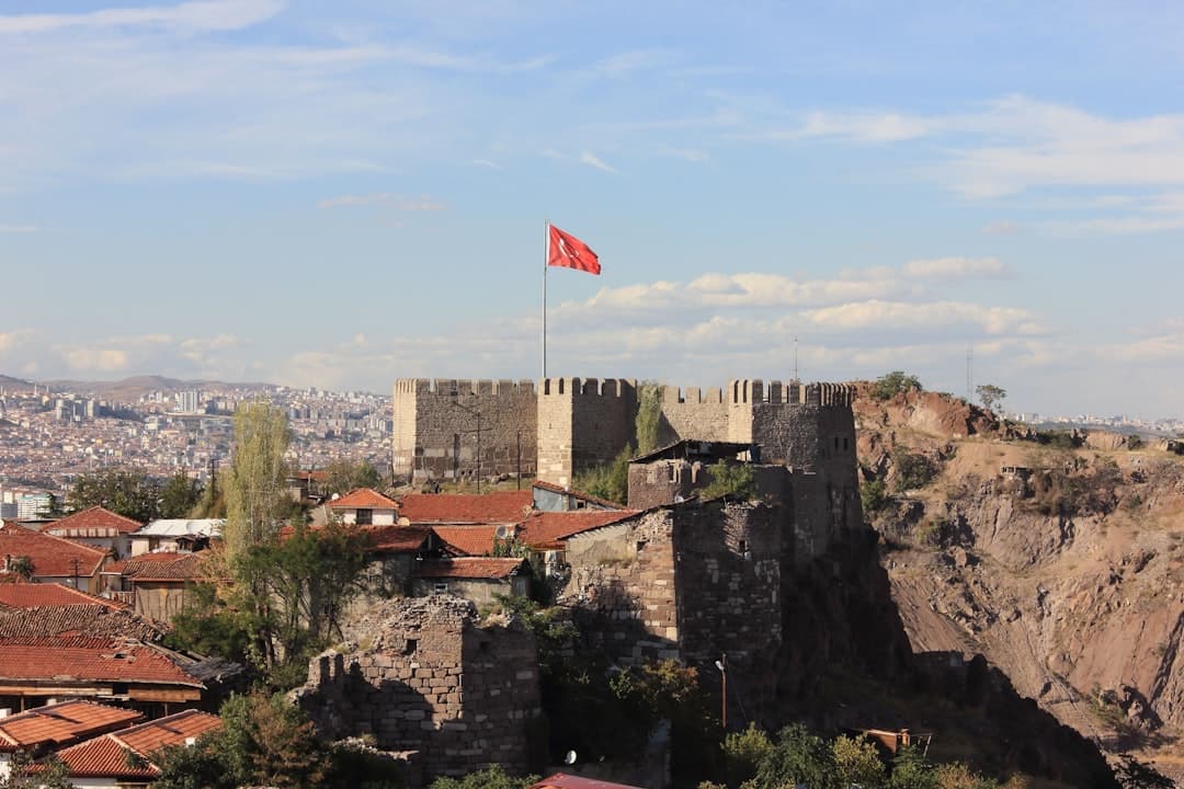 Historyczny zamek Ankara z flagą turecką i widokiem na miasto.