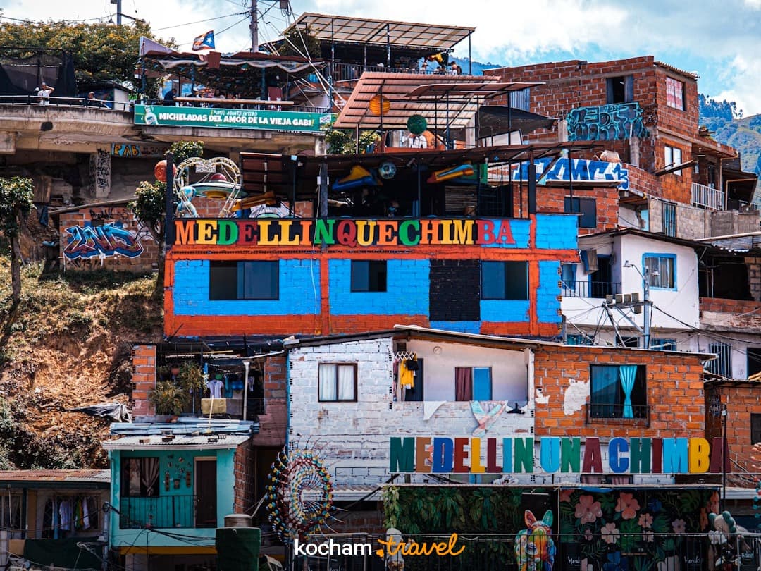 Kolorowe domy, murale na zboczu wzgórza w Medellín, Kolumbia.